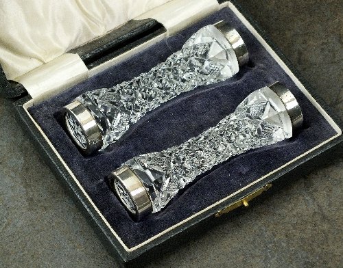 A cased pair of silver mounted cut glass knife rests, I: A cased pair of silver mounted cut glass knife rests, I S Greenberg & Co, Birmingham 1924, each of waisted form with plain polished mount, 10cm long, presented within fitted box