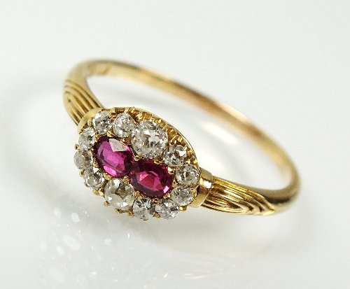 A Victorian 18ct gold ruby and diamond cluster ring,: A Victorian 18ct gold ruby and diamond cluster ring, designed as two oval mixed cut rubies within a graduated border of twelve old cut diamonds, all claw set in yellow gold, the hoop hallmarked Birmin