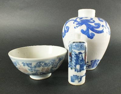 A Chinese small blue and white vase, Qing Dynasty,: A Chinese small blue and white vase, Qing Dynasty, decorated with scrolling floral motifs on a white ground, 14.5cm high, and a Chinese blue, white and copper red porcelain snuff bottle of cylindrical