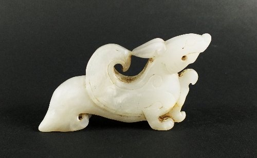 A Chinese mutton fat jade carving of a winged Kylin: A Chinese mutton fat jade carving of a winged Kylin figure, Qing Dynasty, standing with wings folded and head raised, 6.5cm
