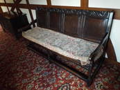 A late 17th/early 18th century oak settle, the leaf