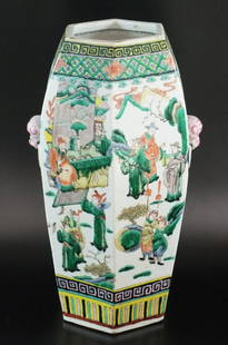 A Chinese porcelain famille verte hexagonal vase, 20th: A Chinese porcelain famille verte hexagonal vase, 20th century, of ovoid form with moulded fu dog form handles, painted with panoramic scenes of the emperor and his entourage in a garden setting betwe