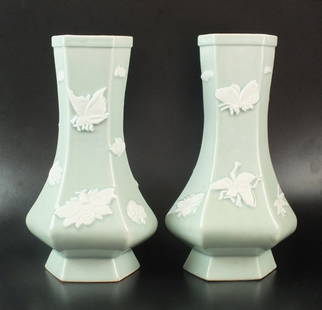 A pair of pale celadon glaze bottle vases, 20th: A pair of pale celadon glaze bottle vases, 20th century, each of six sided form with squat body and elongated neck, decorated with scattered molded insect detailing, 29cm high (2)