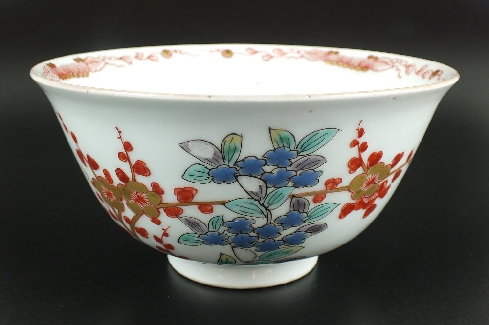 A Japanese Imari bowl, Edo period, late 18th century,: A Japanese Imari bowl, Edo period, late 18th century, with slightly flared lip, the exterior painted with floral designs of kiku and cherry blossom sprays, the interior in rouge de fer with central fl