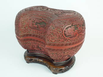 A Chinese cinnabar lacquer ingot form box and cover on