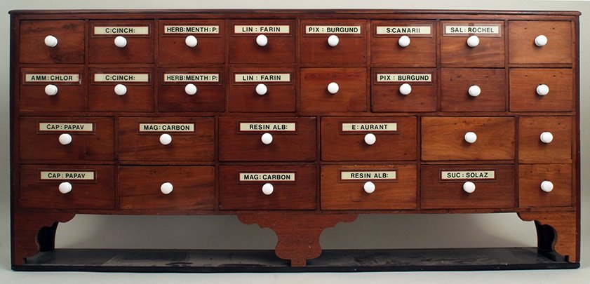 An antique mahogany apothecary's nest of twenty eight: An antique mahogany apothecary's nest of twenty eight drawers, mostly labelled, with later repairs and additions, 69in wide, 31.5in high.