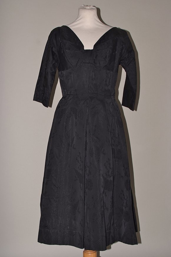 1950's & 60's Vintage Silk Cocktail Dresses. A black: 1950's & 60's Vintage Silk Cocktail Dresses. A black silk brocade dress high waist and stiffened full skirt. A 60's silk cocktail dress with an inner fitted bodice and front bra detail, broken side zi