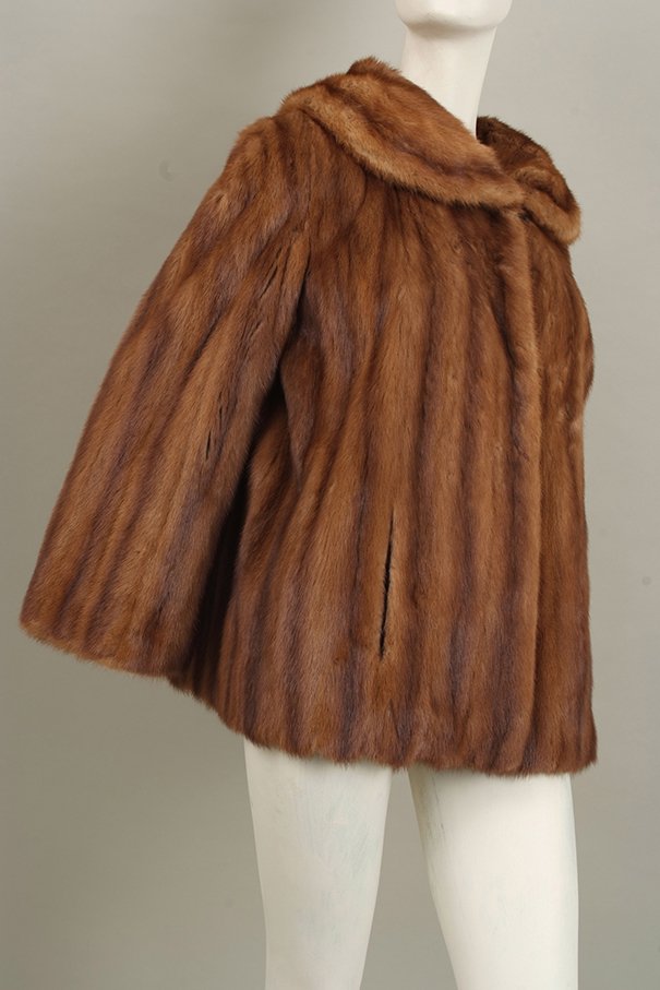 Quantity of furs: A stunning honey coloured soft: Quantity of furs: A stunning honey coloured soft female mink jacket, A white with grey Arctic fox jacket, Two dark brown musquash coats.