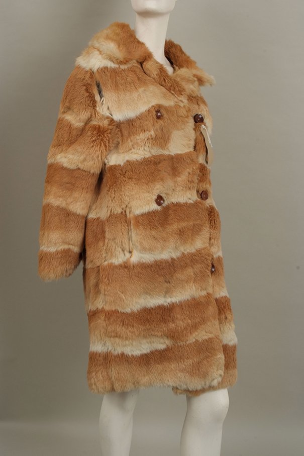 Quantity of furs: Fabulous 1950's Coney Fur coat with: Quantity of furs: Fabulous 1950's Coney Fur coat with honey coloured and cream horizontal pelts, fully lined with wooden buttons. Dark rabbit fur jacket, lined. And dyed mauve musquash jacket.