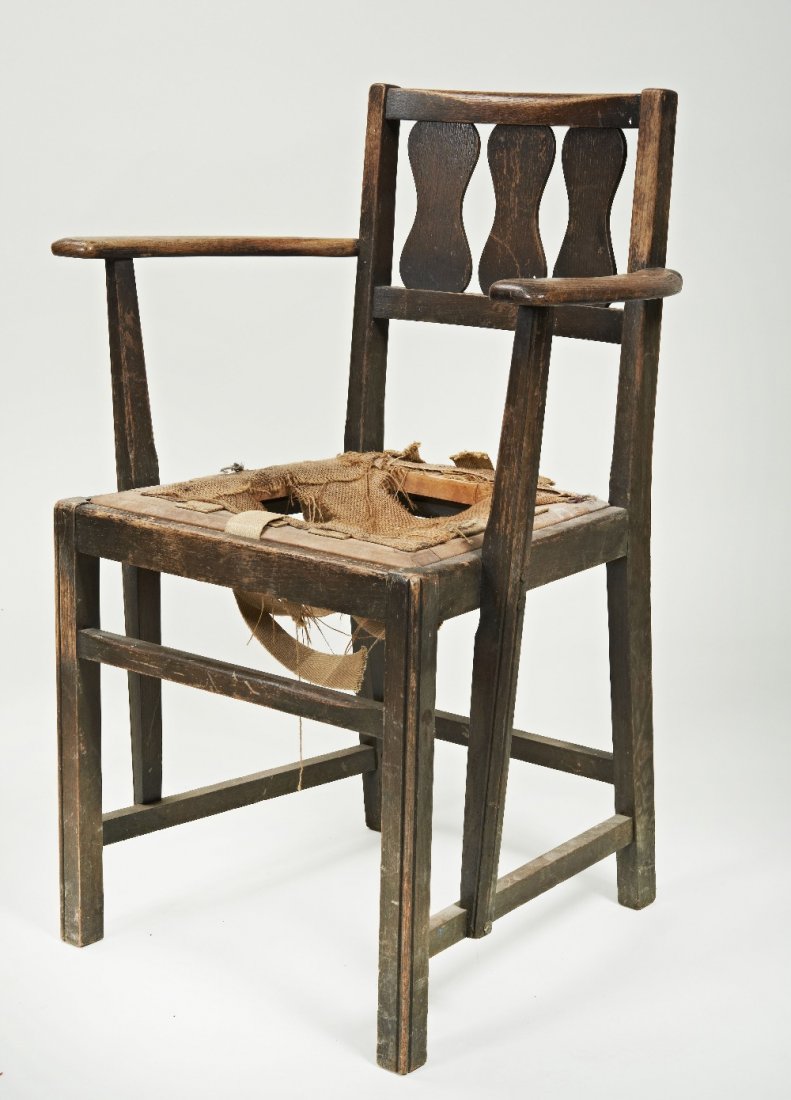 An unusual Ercol ash and oak Arts & Crafts armchair,: An unusual Ercol ash and oak Arts & Crafts armchair, 1920's, the low back with three baluster splats continuing to shaped arms above drop in seat and square section legs, bears paper label Ercol Produ