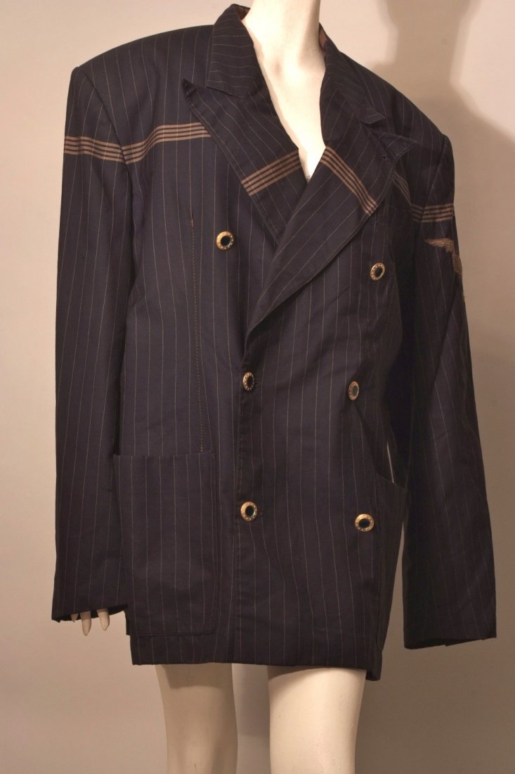 A 'Jean Paul Gaultier Homme' Jacket. Black and gold: A 'Jean Paul Gaultier Homme' Jacket. Black and gold Pin- striped double breasted jacket with thick horizontal gold lines, padded shoulders with a lace Eagle applique on left hand shoulder. Gold and gr