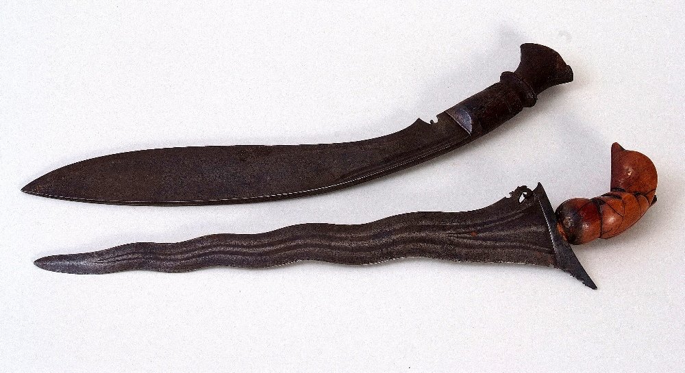 An Indonesian Balinese Kris dagger, 19th century,: An Indonesian Balinese Kris dagger, 19th century, shaped balde, bone hilt in the form of a bird, blade 33cm, with an early 20th century Kukri Gurkha dagger, with shaped wooden hilt, blade 30cm