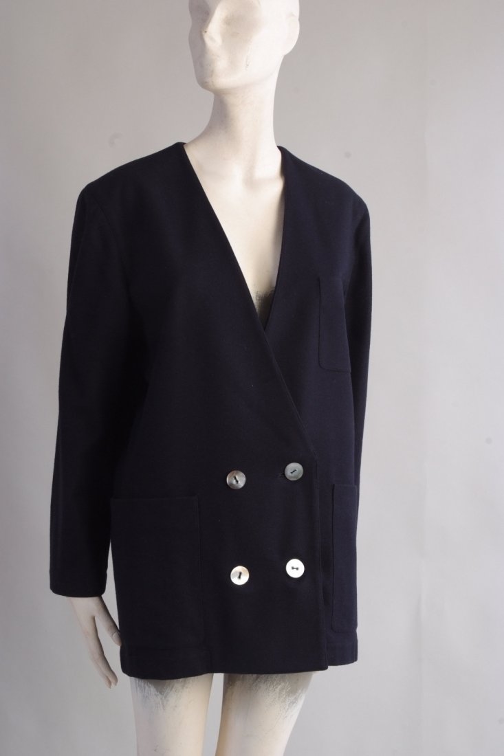 A 'Salvatore Ferragamo' Pure wool Ladies Jacket. A very: A 'Salvatore Ferragamo' Pure wool Ladies Jacket. A very sophisticated, light woollen dark blue collarless jacket. In excellent condition. Size 14. (1)