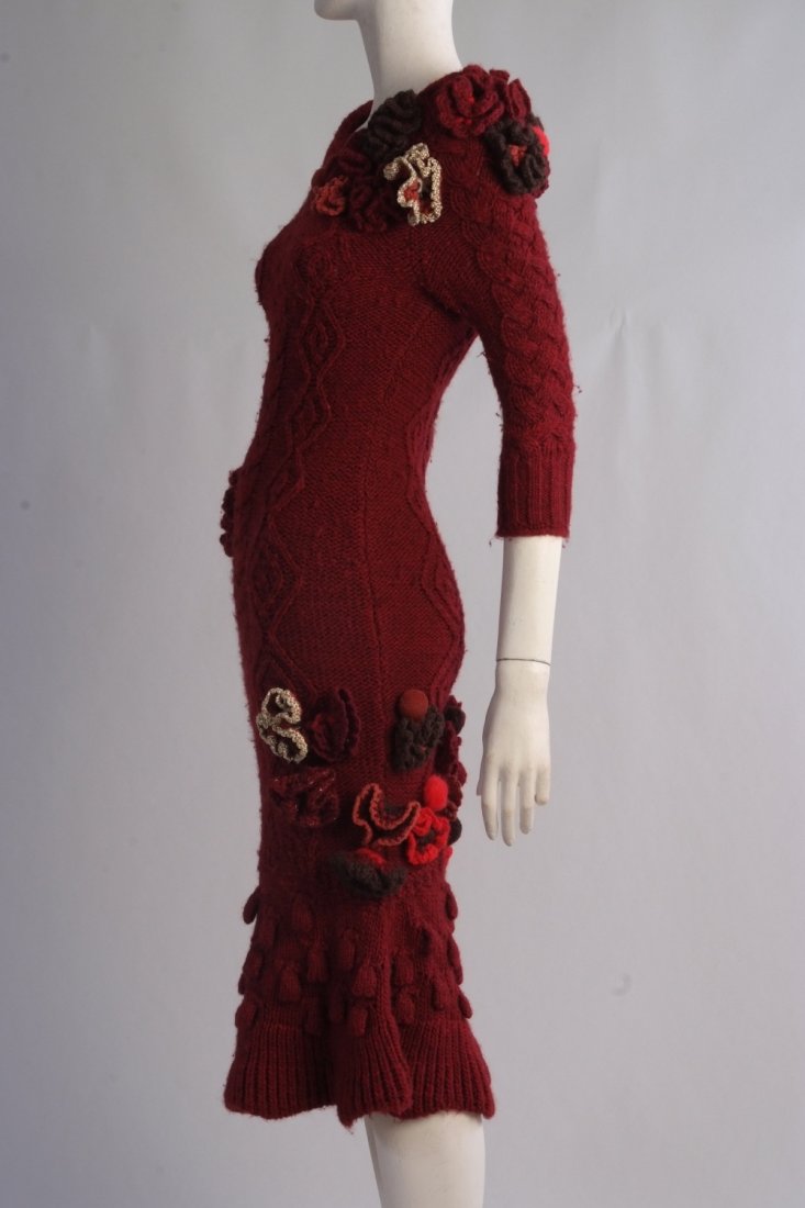 A Rare 'Alexander McQueen' Cable knitted dress. A truly: A Rare 'Alexander McQueen' Cable knitted dress. A truly stunning and rare red cable knit dress made in Italy. Ornamented with flowers and fruits. Size 8.