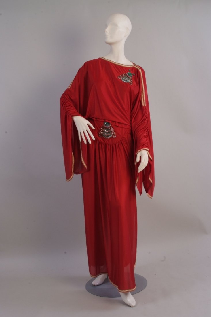 A 1972 Bill Gibb Bee motif Ensemble. A slinky rust red: A 1972 Bill Gibb Bee motif Ensemble. A slinky rust red colourful draped silk jersey blouse and skirt, with romantic long voluminous sleeves and his classic 'bee' motif which he was so famous for encru
