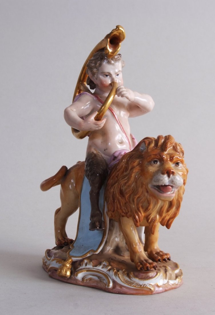 Meissen figurine group of a putto riding a lion and: Meissen figurine group of a putto riding a lion and playing a horn, circa 1880, Meissen crossed swords mark to base, damage to tail, 20cmH