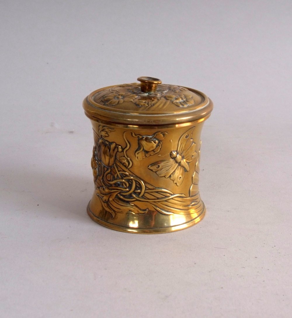 An Art Nouveau brass string box, circular form,: An Art Nouveau brass string box, circular form, decorated with flowers, butterflies, and the profile of a woman, 8cmH