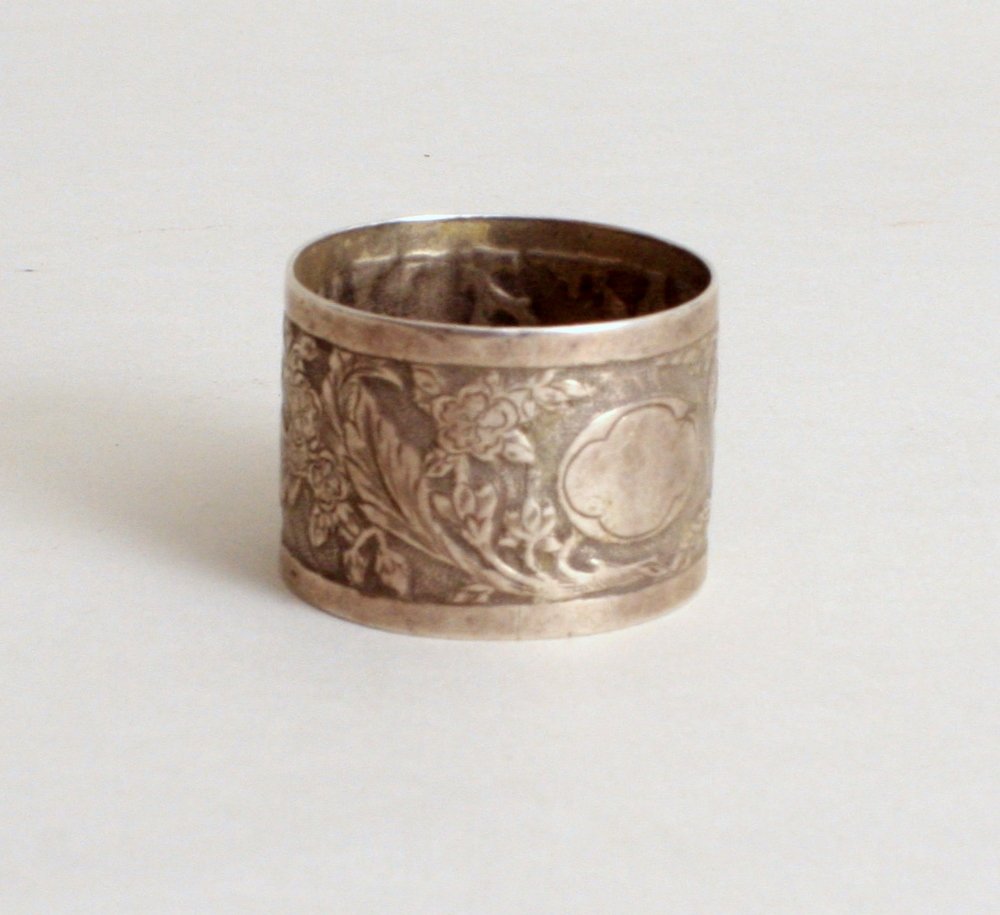 A Victorian silver napkin ring, by Frederick Elkington,: A Victorian silver napkin ring, by Frederick Elkington, Birmingham 1888, decorated with Yorkshire roses and vine, 1oz