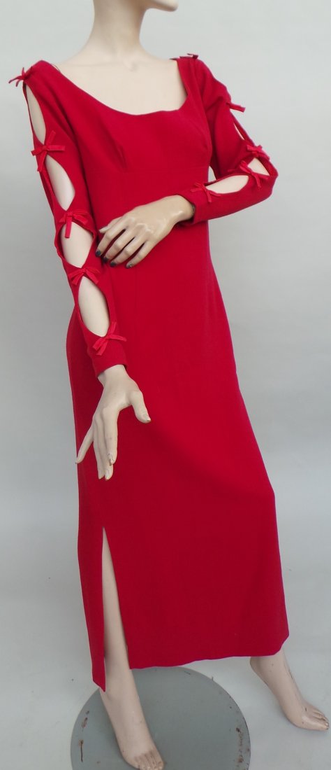 A stunning 1960's 'Jean Varon' lined red wool crepe: A stunning 1960's 'Jean Varon' lined red wool crepe full length dress. The garment is empire style with a broad neck leading to cut away areas from the shoulders down through the sleeve to the cuffs w