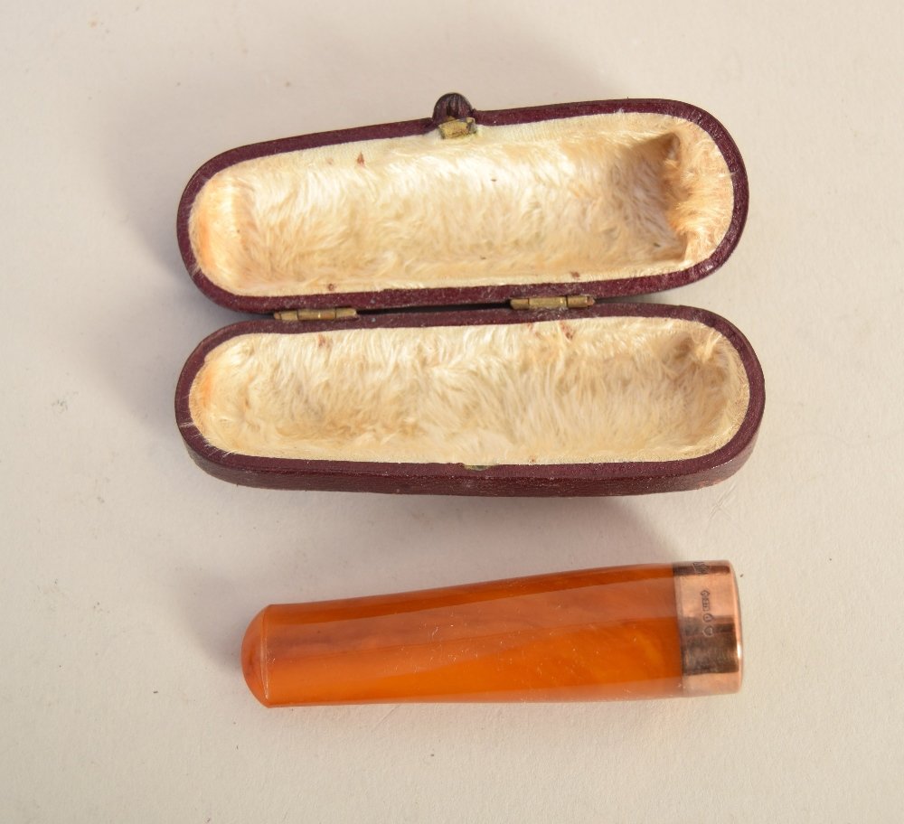 An Art Deco 9ct gold mounted amber cigar holder, N.C: An Art Deco 9ct gold mounted amber cigar holder, N.C makers mark, in leather case stamped W. Larbalestier, Southampton, 6.5cm
