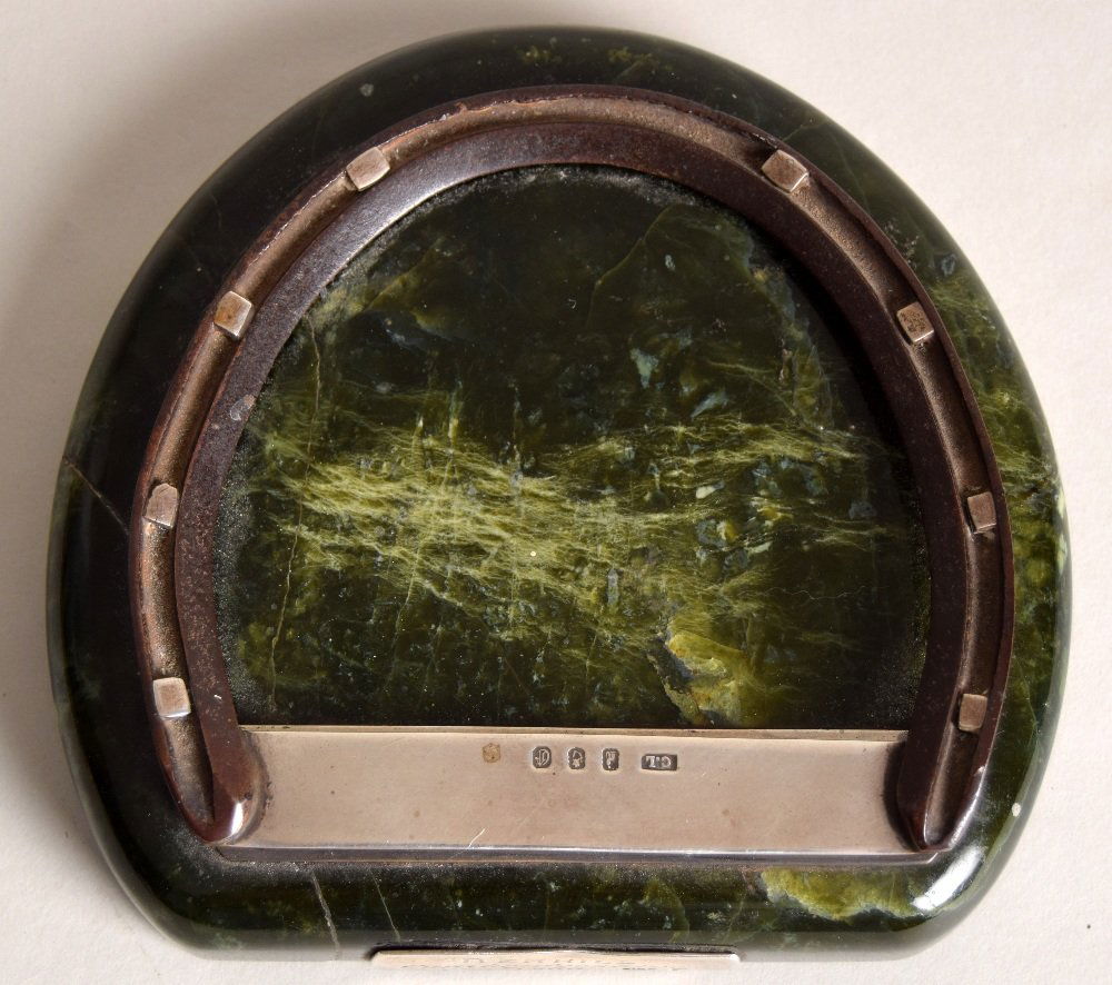 Horse Racing Interest: A late Victorian racehorse shoe: Horse Racing Interest: A late Victorian racehorse shoe and Connemara marble desk clip with silver hinged mount and label engraved 'Berrell Cambridgeshire 1900', the silver mounts hallmarked for Dublin