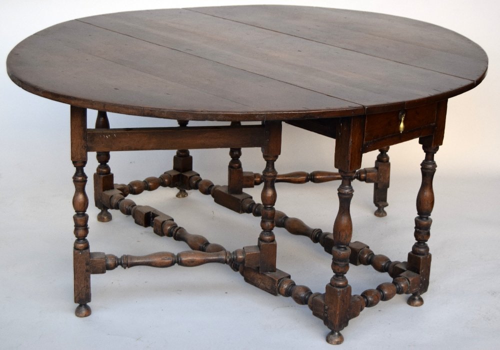 An oak gate leg table of large size with end drawer on: An oak gate leg table of large size with end drawer on baluster turned frame 130cmW x 74cmH