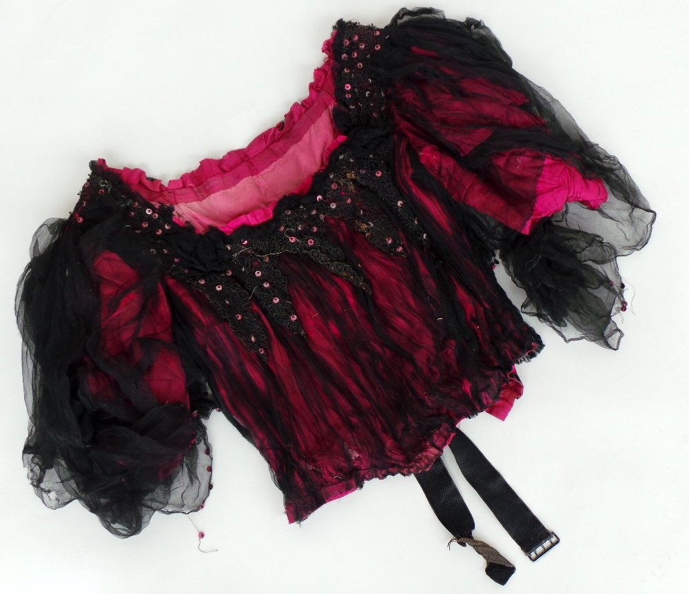A fine elegant Edwardian cerise pink silk bustiere: A fine elegant Edwardian cerise pink silk bustiere over- layered with black silk chiffon. The black chiffon outer layer supports a stretch of black sequinned crochet to frame the broad neck. The garme