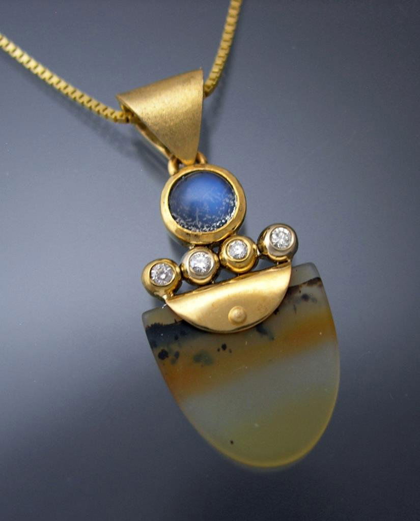 Custom 14k Montana Agate, Diamond & Moonstone Pendant: 14k yellow gold Montana agate tongue pendant with 4=.08ct diamonds and moonstone. 4 grams total weight. Chain sold separately (email for details). The use of traditional techniques creates a visual co