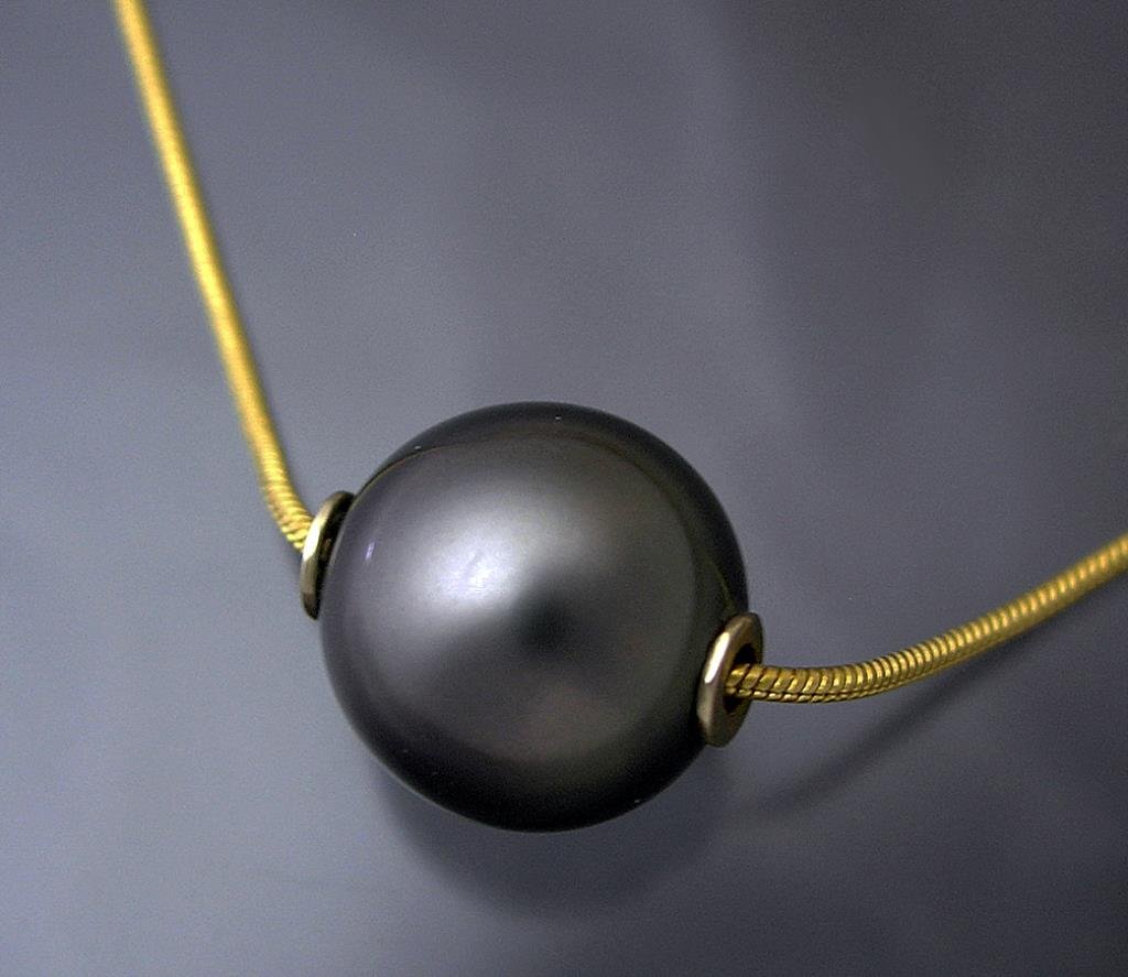 Black Pearl Floater & 14K Chain: 14k yellow gold 11mm black Tahitian pearl on snake chain. 5.3 grams total weight. The ultimate in minimalism! Gold inserts protect the pearl from abrasion with the chain.