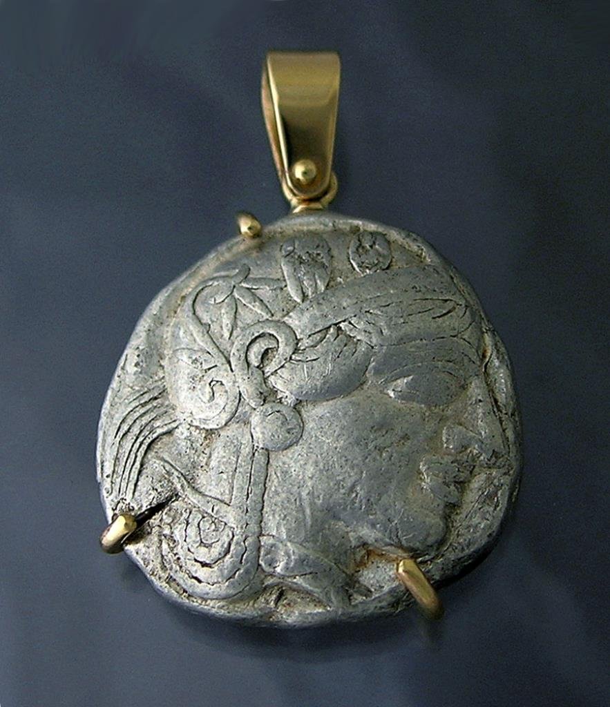 Ancient Greek Silver Athenian Tetradrachm Set in 14k: Athens, 5th Century BCE. A silver Athenian Tetradrachm with Athena on front and an owl on back. Ancient chop marks visible on back. Set into a custom-designed 14k gold pendant by Eric Olson. 18.9 gram
