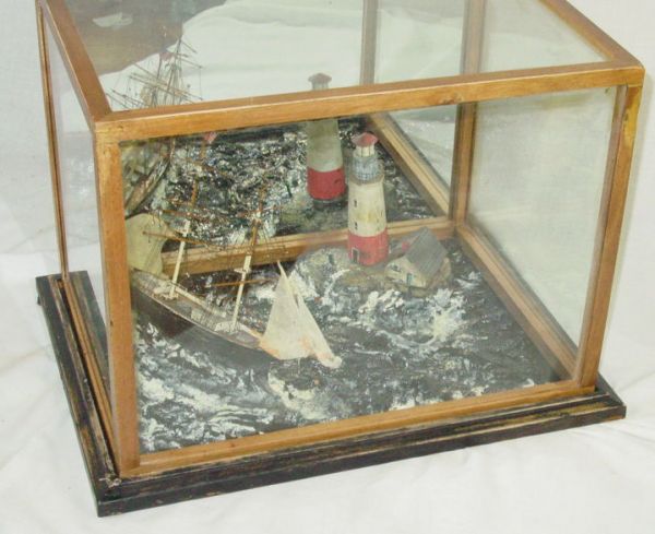 Nautical shadow box - diorama of floundering ship: Nautical shadow box/diorama of floundering ship in storm off the coast, lighthouse in background - lighthouse keeper waving from shore to sailors on board, turn of century, MIRRORED BACK - ONE LIGHTHO