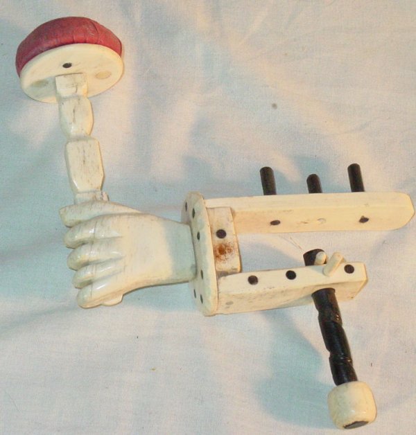 bone, ivory and ebony table mount sewing stand in: bone, ivory and ebony table mount sewing stand in fist form, 10" x 7", good condition, old age cracks