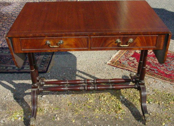 Georgian mahogany drop leaf library table: Georgian mahogany drop leaf library table with Duncan Phyfe style legs with brass caps, circa 1810, 36" x 23" x 29" plus two 9" leaves, repaired leg