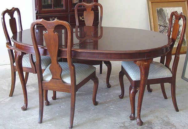 Custom mahogany dining table and chairs,: Custom mahogany dining table and chairs, solid mahogany Queen Anne style dining table with four chairs (one arm) 65" X 44" plus 2 19" leaves, excellent condition
