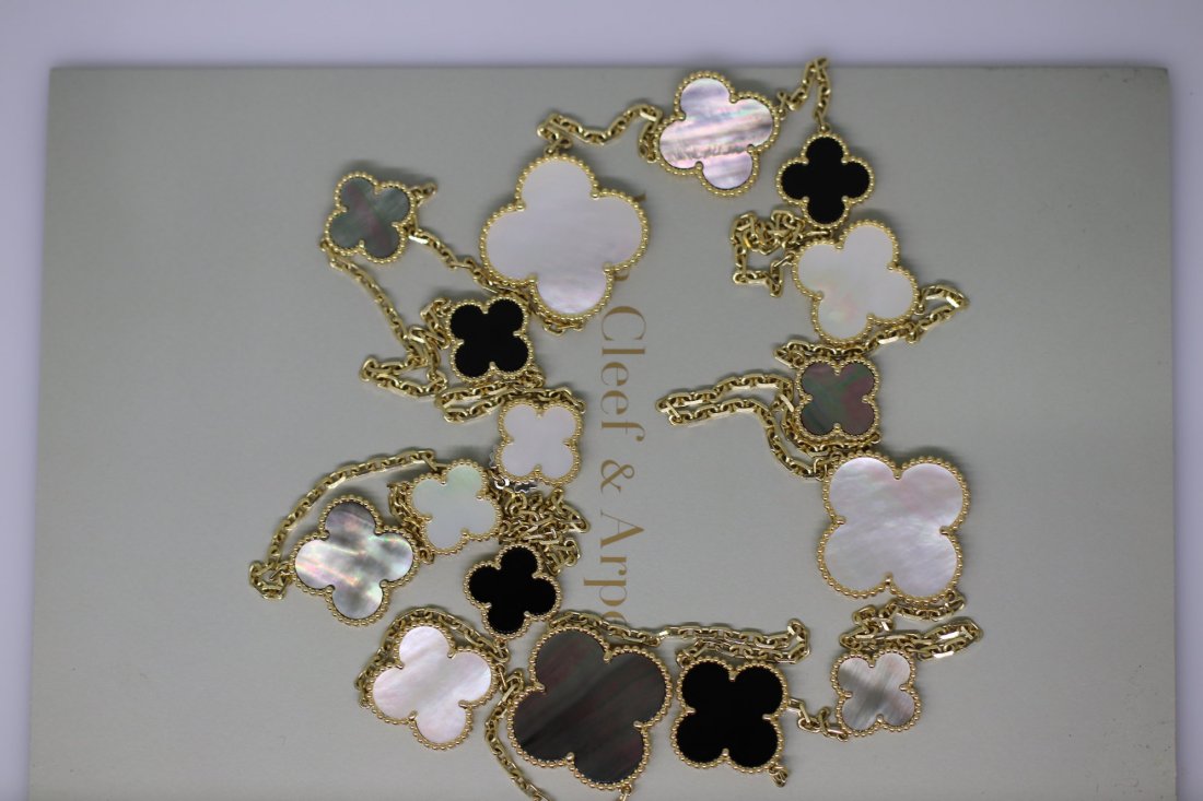 Van Cleef & Arpels Magic Alhambra 16 Motif Necklace: 18k Yellow Gold, White & Grey Mother of Pearl, Onyx motifs, 48 inches in length, Hallmarks: VCA 750, Serial Numbers, makers mark, arrives with Certificate of Authenticity from Van Cleef & Arpels