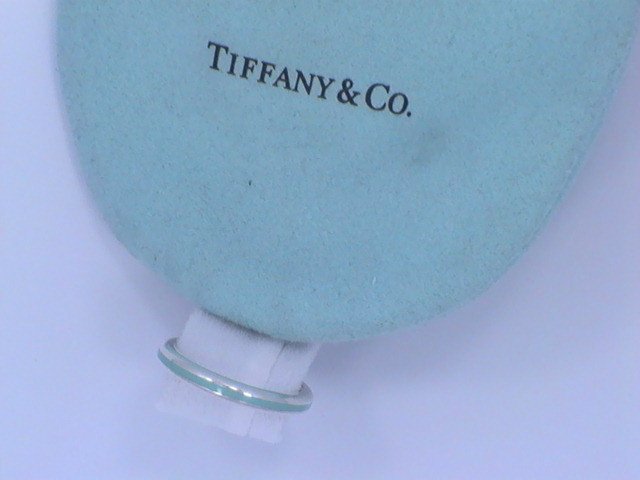 Tiffany & Co.Sterling Silver Blue Enamel Band Ring "NR: Tiffany & Co. Sterling Silver .925 Blue Enamel Band Ring. The Ring has a blue enamel going around the middle of the ring with silver on the side around the ring. "Tiffany & Co. AG925". This piece will