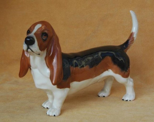 Beswick England Porcelain Basset Hound Dog 8": This is a fine figure of a Basset Hound from Beswick designed by Arthur Gredington. A wonderful model with long ears and big sad eyes, good form and movement and beautifully hand painted. measures app