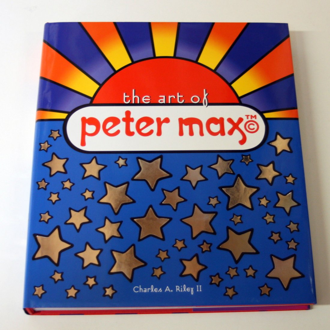 THE ART OF PETER MAX BY CHARLES RILEY HARDCOVER BOOK: THE ART OF PETER MAX 240 PAGES HARDCOVER, COLOR BOOK WITH SLIPCOVER Measures Approx: 14" x 10.5".