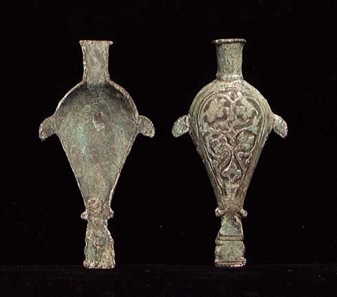 EARLY ISLAMIC BRONZE OIL LAMP FILLER: EARLY ISLAMIC BRONZE OIL LAMP FILLER, c. 7th-10th c. With ornate Islamic floral design on the bottom. 3.5". Rare and artistic design.Provenance: An extensive 20th century New Jersey collection. Assemb