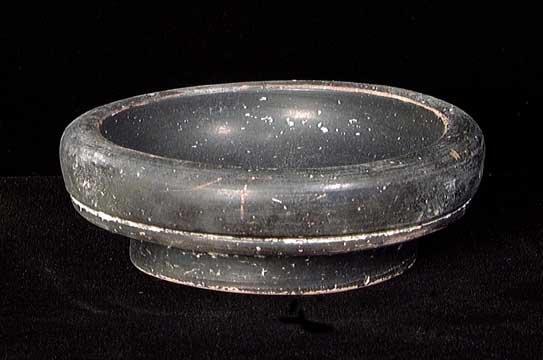 GREEK BLACK-GLAZED DISH: A GREEK BLACK-GLAZED DISH, c. 4th century BC. On ring base with shallow bowl and carinated rim. 3.75" in diameter. Provenance: An extensive 20th century New Jersey collection. Assembled over the past 