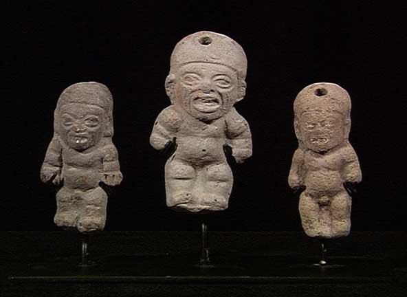THREE TUMACO-LA TOLITA FIGURES: PRE-COLUMBIAN. EXPRESSIVE SET OF THREE TUMACO-LA TOLITA FIGURES, ca. 300 BC - 200 AD. The three very similar in style, a very nice set. To 2.4". On a custom stand. Provenance: An extensive East Coast 