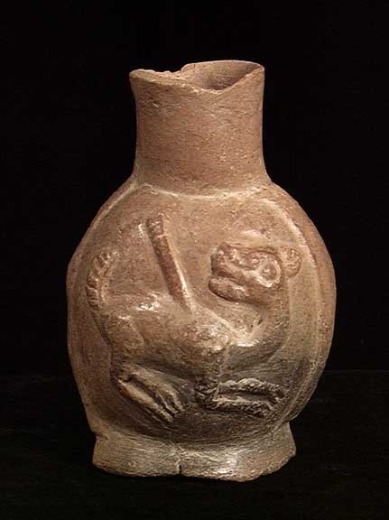 MOCHE VESSEL WITH SPEARED LLAMA: PRECOLUMBIAN.MOCHE VESSEL WITH SPEARED LLAMA. Peru, c. 100-800 AD. The burnished umber vessel with a molded llama which turns its head toward a spear embedded in its back. The scene repeated on both s