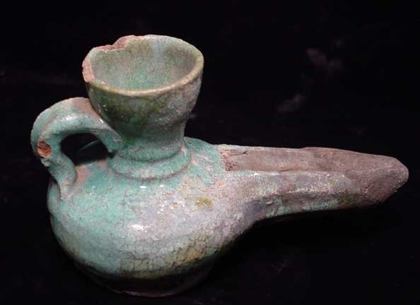 EARLY ISLAMIC TURQUOISE GLAZED OIL LAMP: EARLY ISLAMIC GLAZED OIL LAMP, c. 7th-12th century AD. Green glazed lamp with long spout (tip restored). 5.75 inches. Scarce.Provenance: An extensive 20th century New Jersey collection. Assembled over