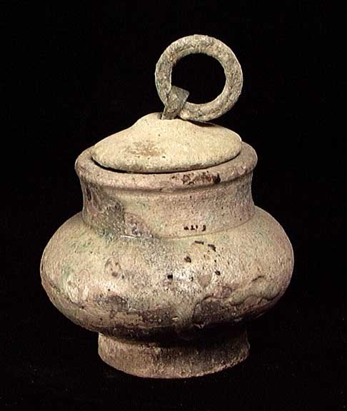 EARLY ISLAMIC LIDDED PYXIS: EARLY ISLAMIC LIDDED PYXIS, ca. 7th-11th century AD. The ceramic pot with remains of turquoise glaze, the intact lid wit original bronze ring. 3.5 inches. Intact. Quite rare.Provenance: An extensive 2