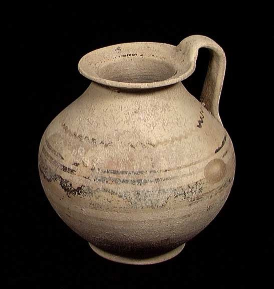DAUNIAN GREEK OLLA: A DAUNIAN GREEK OLLA, ca. 5th century BC. The vessel with a single strap handle from the shoulder to the wide everted rim, the body with remains of bands and designs of slate blue and red. 6.5 x 7". P