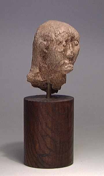 VERY RARE EARLY VILLANOVAN HEAD: EARLY VILLANOVAN TERRA COTTA HEAD, ca. 8th-7th century BC. Abstractly modeled head of a man or god with long hair over the shoulders in back. A very rare early type. Dimensions: 2 x 2 x 3.5". Provenan
