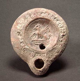 ROMAN OIL LAMP WITH GRIFFIN: A ROMAN OIL LAMP, c. 1st-3rd century. The lamp with a seated griffin on the discus. 3.8". Provenance: An extensive 20th century New Jersey collection. Assembled over the past 35 years.All pieces have