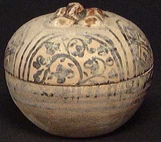 PUBLISHED IN 'ORIENTAL ANTIQUES AND ART': PUBLISHED SAWANKHALOK COSMETICS JAR. Thailand, ca. 14th century. The lidded vessel in the form of a persimmon with applied iron brown designs. 2.1 x 2.5 inches. Excellent condition and a beautiful lit