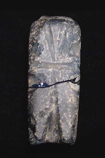 BYZANTINE MOLAR FLASK WITH WHEEL CUT CROSSES.: BYZANTINE MOLAR FLASK, c. 5th-7th century AD. The vessel of opaque blue-black glass with wheel cut Christian crosses on the sides. 2 inches. The 'molar' flasks are named due to their forms resembling 