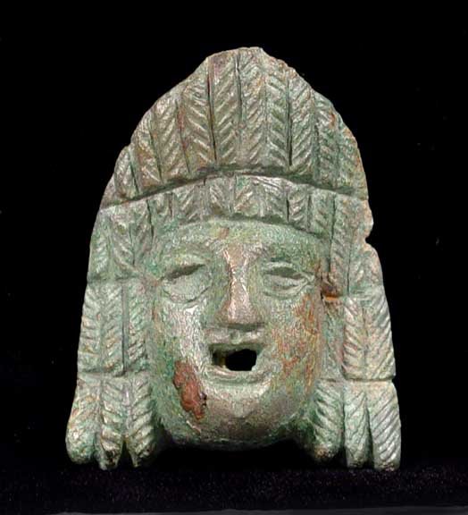 SIZABLE ROMAN BRONZE ACTOR’S MASK: SIZABLE FINE ROMAN BRONZE ACTOR’S MASK, c. 1st-2nd century AD. Fine depiction of the classical actor's mask. 2 x 2.5 inches. Likely it once graced the handle of an exceptional Roman bronze oil lamp.